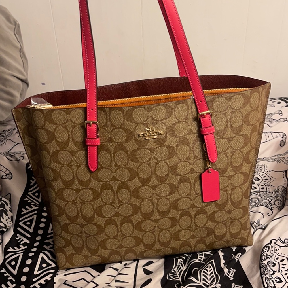 Selling a brand new coach bag with IM/khaki electric pink still has the tag on